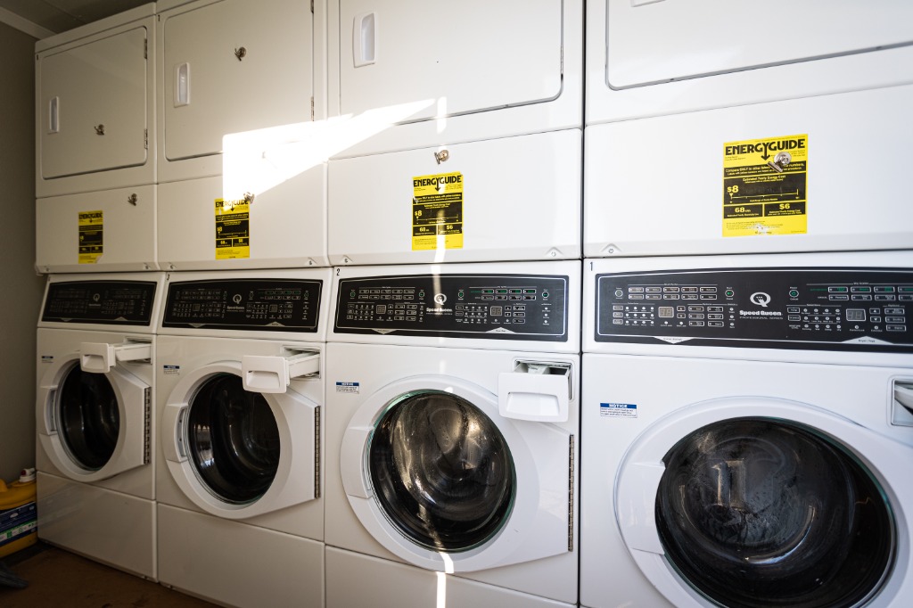 Interior of the Laundry Angels trailer showing high-capacity Speed Queen washers and dryers